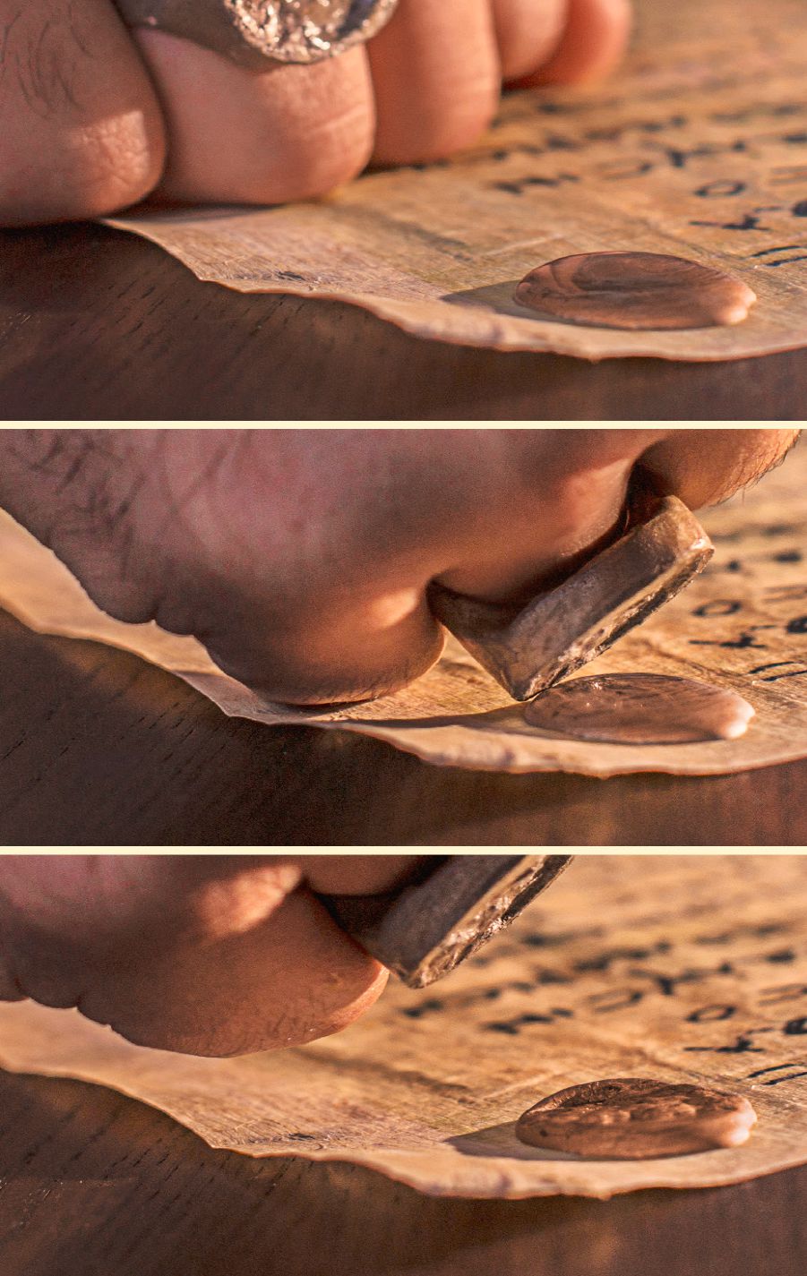 A person presses a seal ring into clay on a document