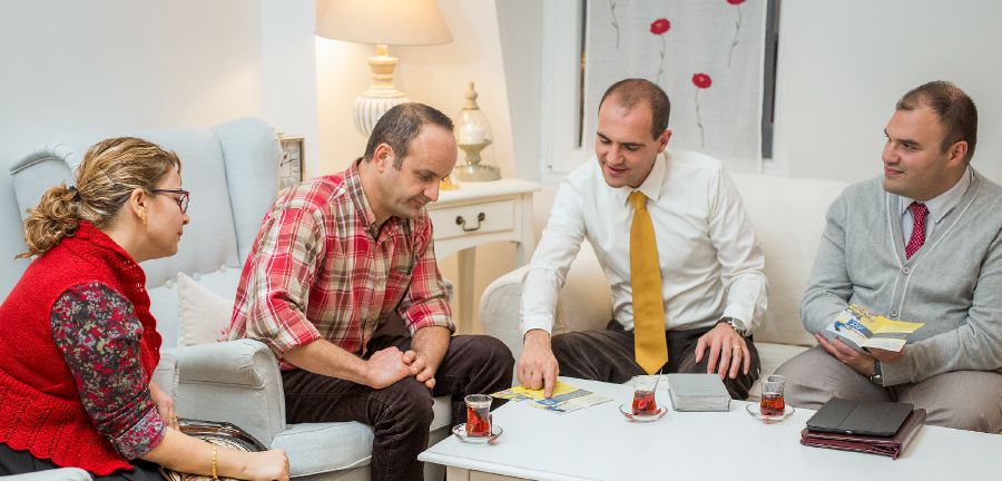 Jean-David preaches to people in their home