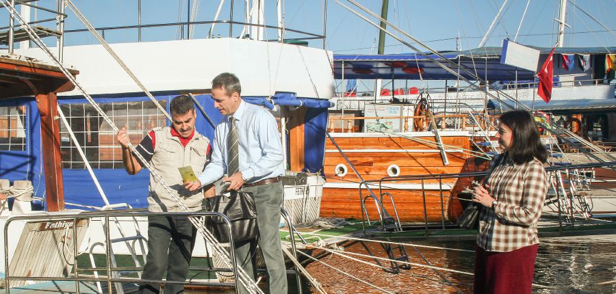 Federico preaches to a man at a marina