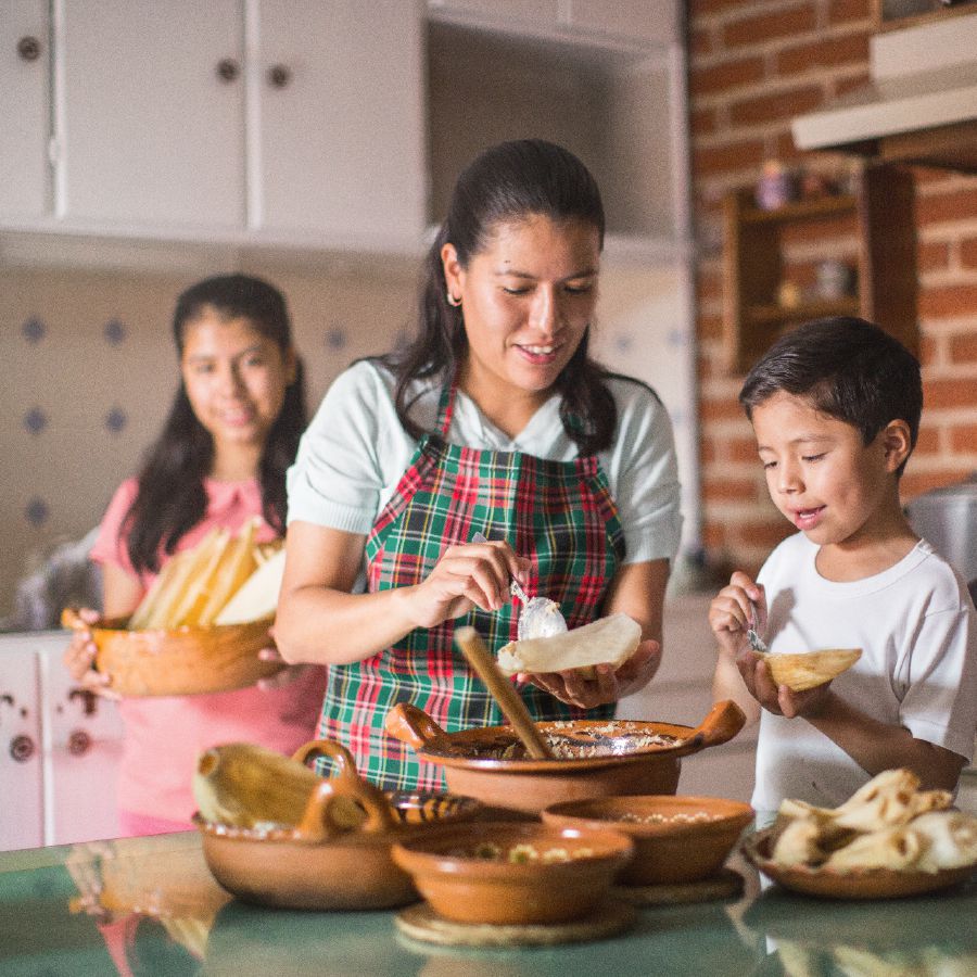 A mother and her children prepare food for guests