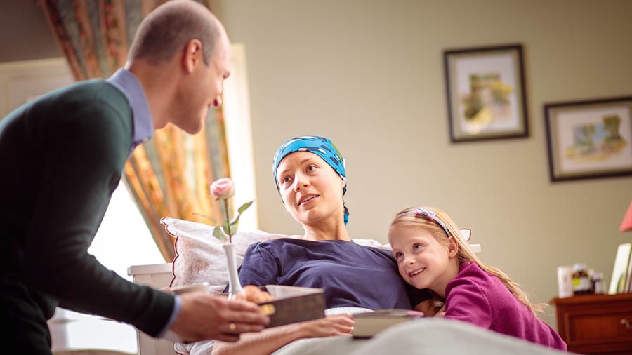 In the 1980’s a husband cares for his wife while she is ill; the couple’s young daughter looks on