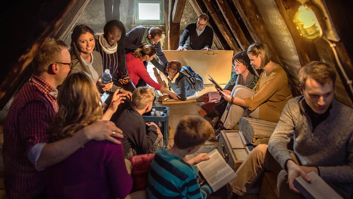 Brothers and sisters encourage one another in an attic during the great tribulation