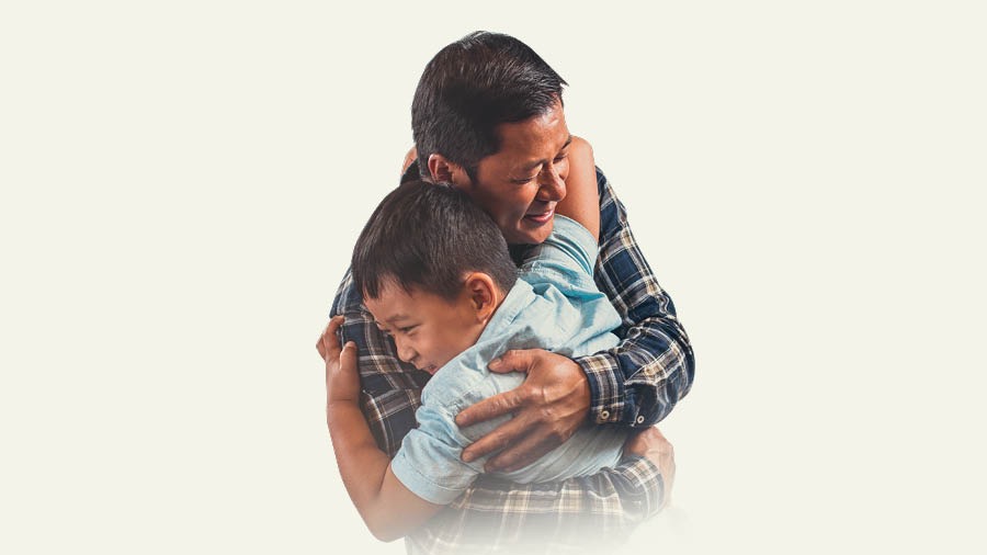 A father embracing his young son.