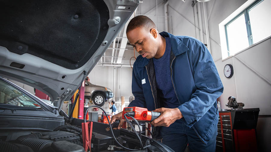 A brother working secularly as a mechanic in an auto shop.