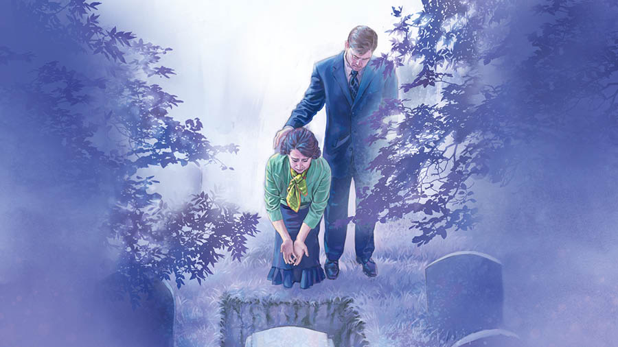 A couple at a cemetery, weeping as they look at a coffin that has been lowered into a grave.