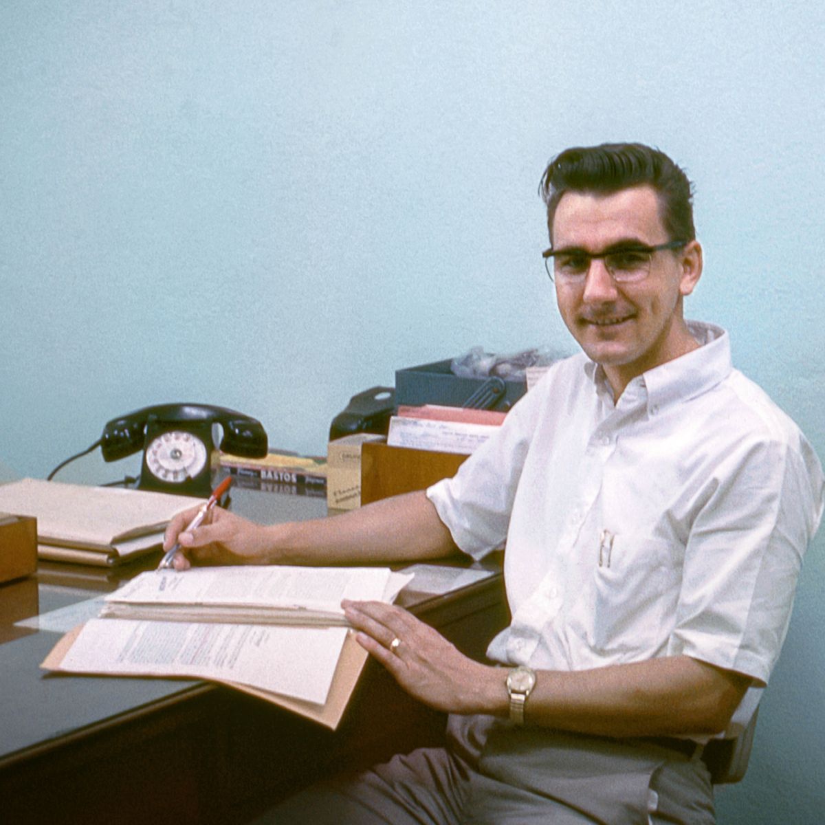 André sitting at his desk in Cameroon.
