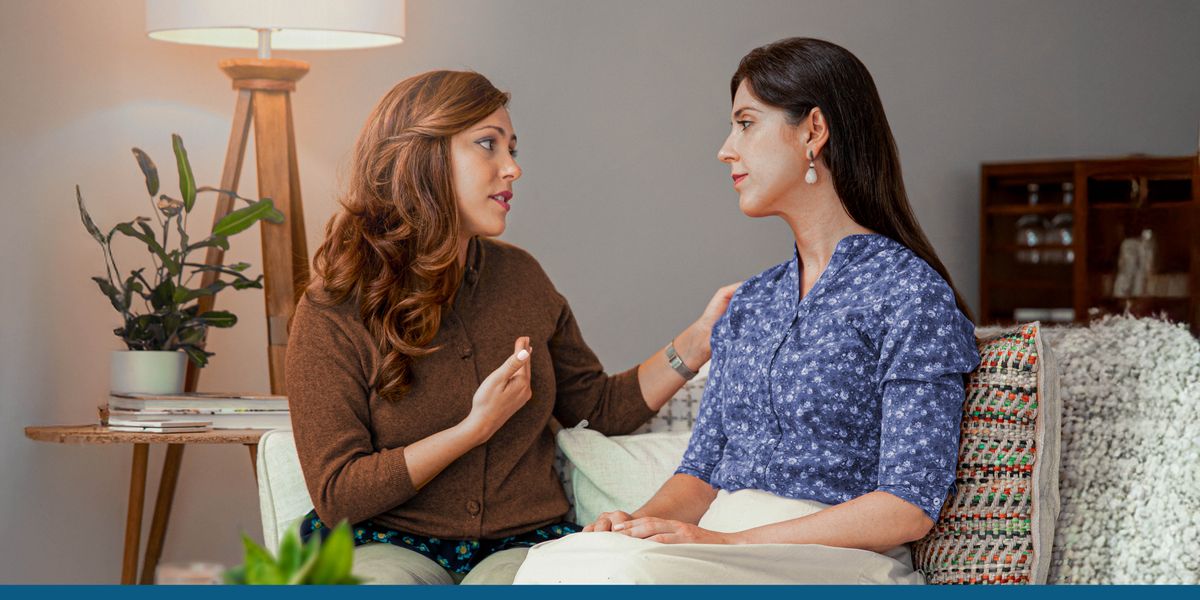 A sister sincerely apologizing to another sister in one of their homes.
