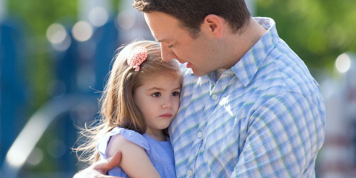 A father holds his little girl