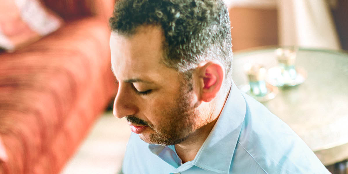 A Middle Eastern man praying.