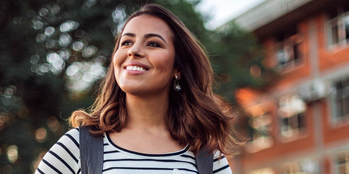 A young woman smiling.