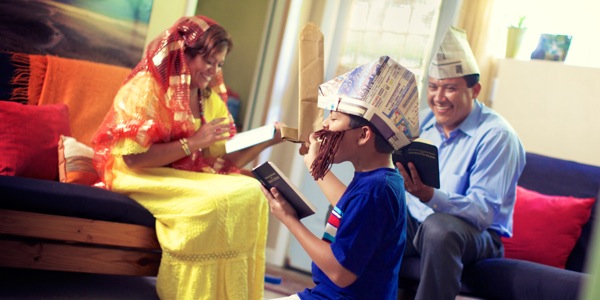 A family acting out a Bible story during their family worship