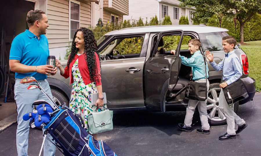 Before a sister leaves with her two boys for field service, she says goodbye to her husband who is ready to go play golf