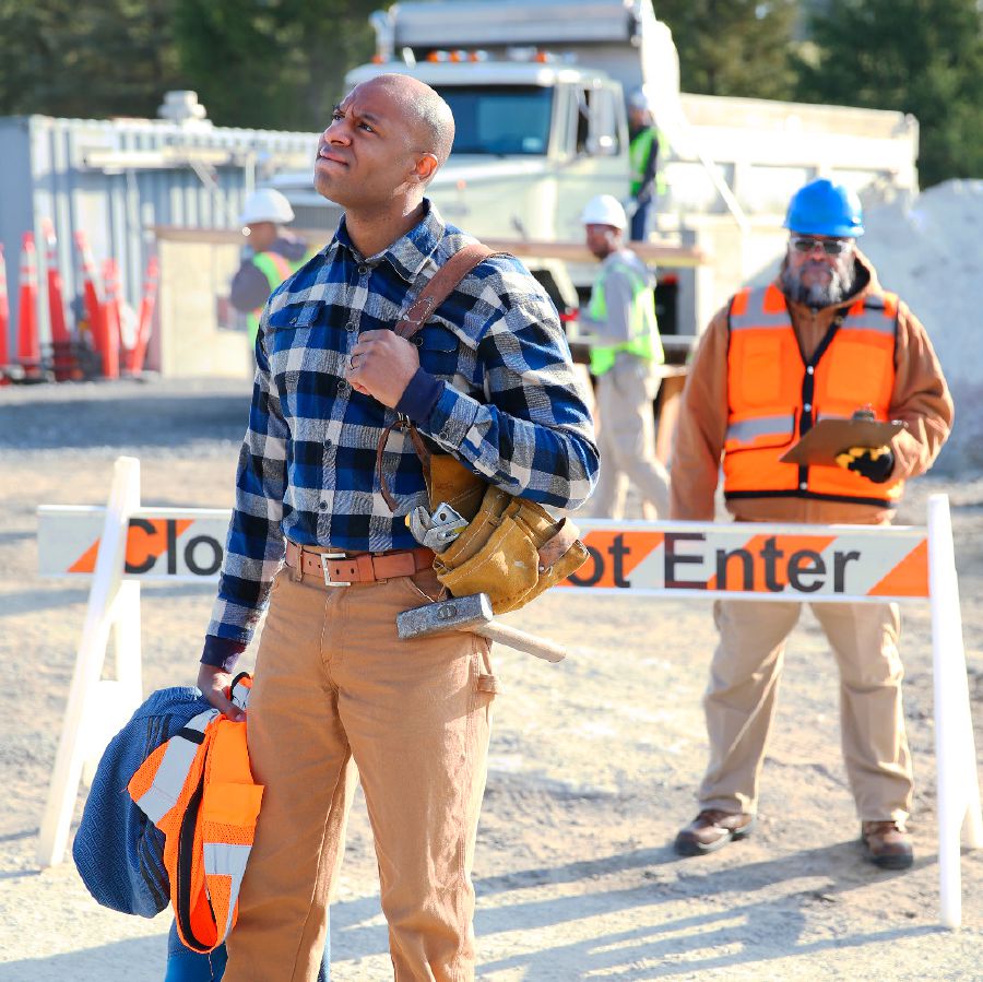 A brother walks away from a work site after losing his job