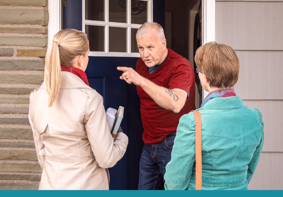 A man responds harshly to two sisters who call at his door