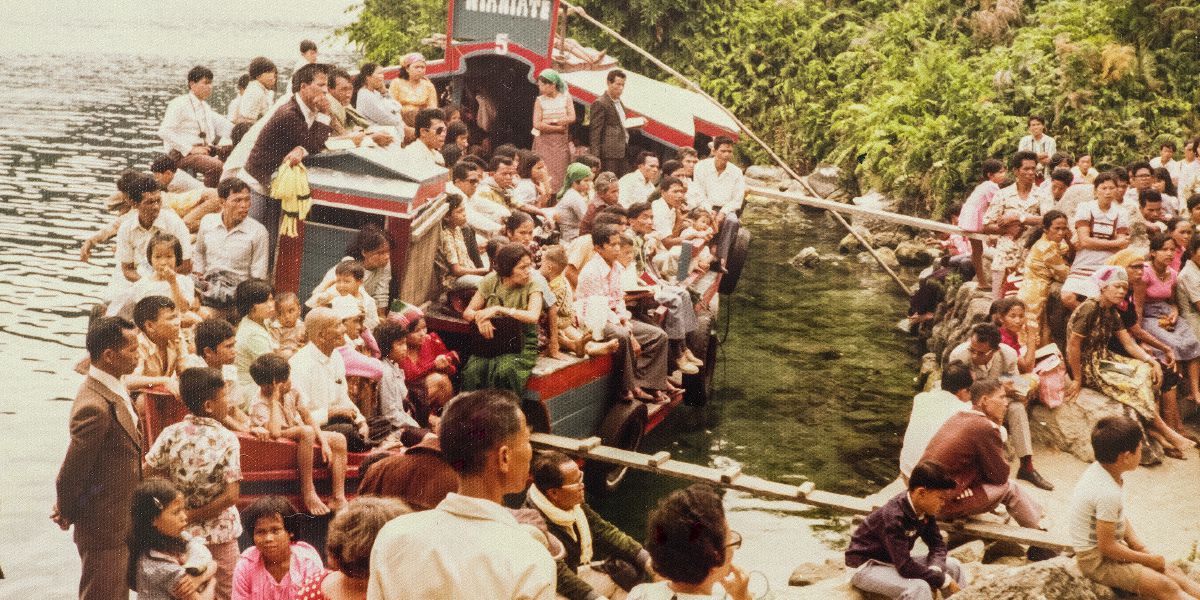 During an assembly under ban in Indonesia, part of the audience listens from a boat