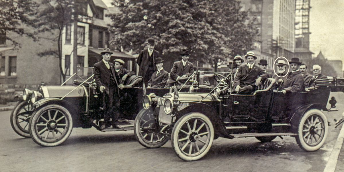 Brother Russell sits in a car with a group of pilgrims