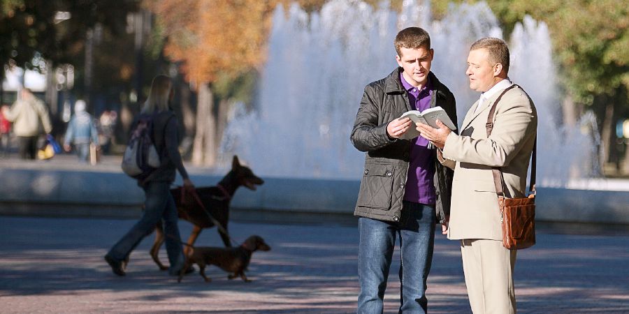 Vitaliy Shalaiko preaches to a man in Ukraine