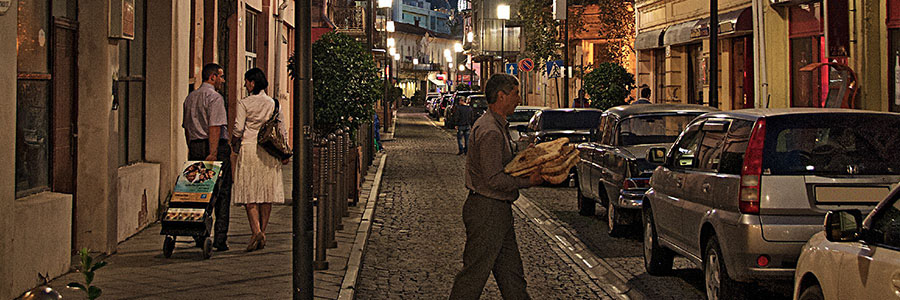 A couple pulls a public witnessing cart down a street