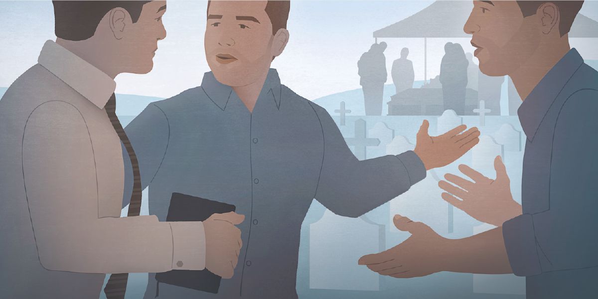 دو مرد در قبرستان در حال گفتگو با یک شاهد یَهُوَه.‏ یک مرد با انگشت به سمت مراسم ختم اشاره می‌کند.‏