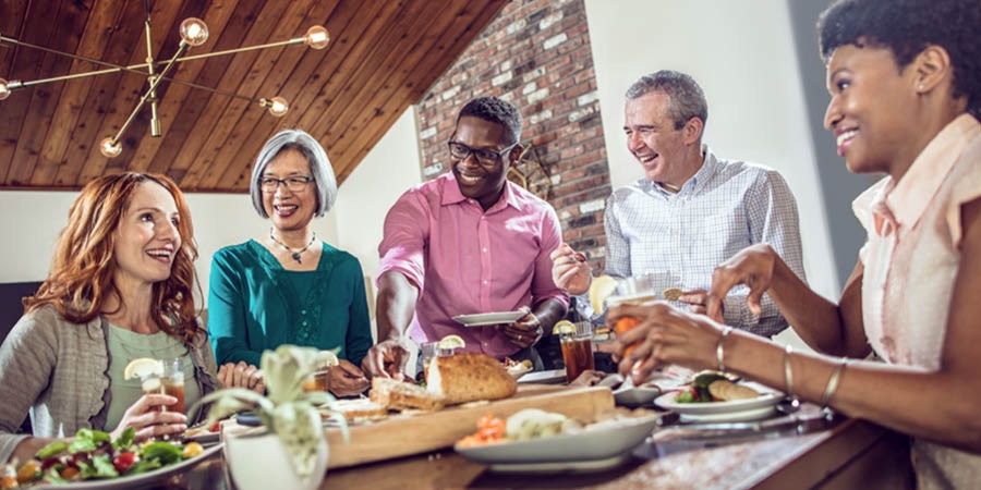 Des amis de différentes origines partagent un repas