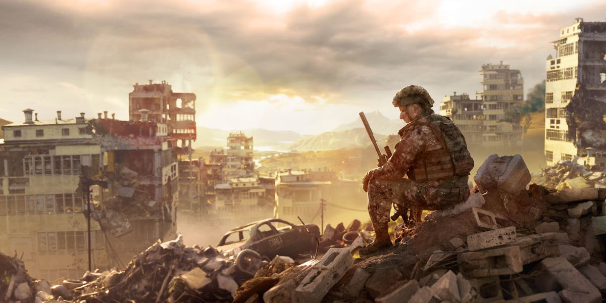 Un soldado meditando sentado enriba do cascote dunha cidade destruída pola guerra.