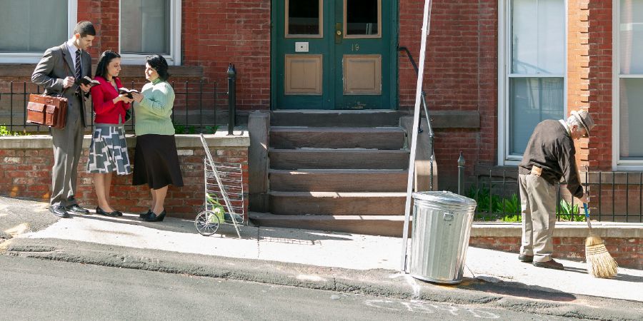 A couple preach to a woman on the street.