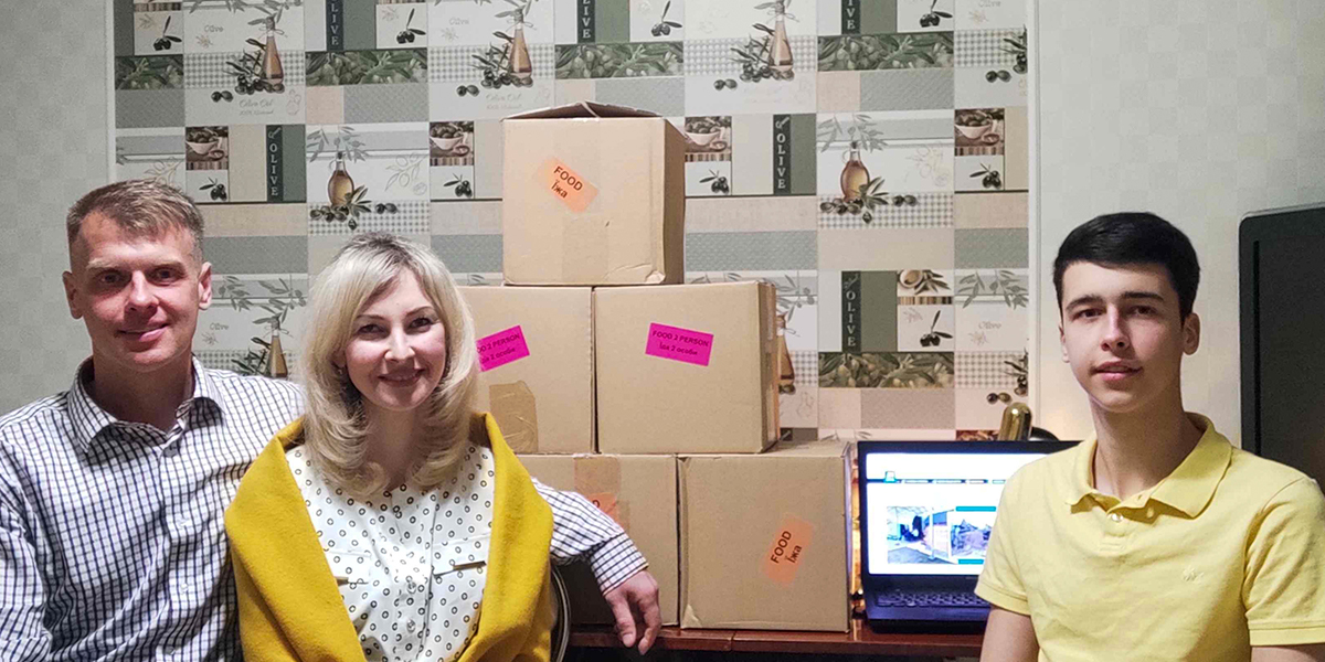 Yevhen, Iryna, and Mykyta with the relief packages they received.