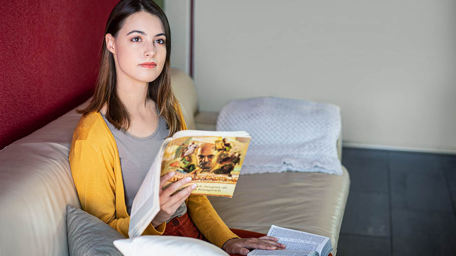 Sestra razmišlja o onome što je pročitala u Bibliji i traži dodatne informacije u knjizi ‘‘Temeljito svjedočimo’ o Božjem Kraljevstvu!’