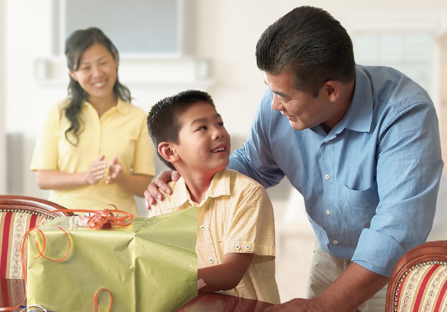 Parents give their young son a gift