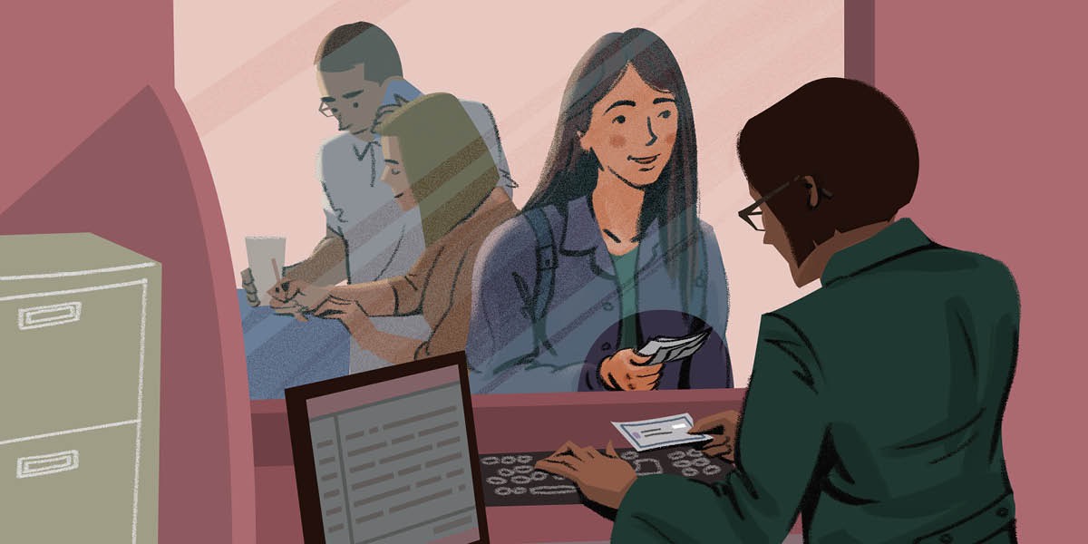A young woman makes a payment at a bank