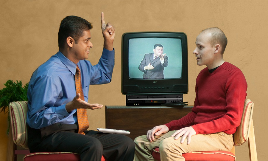 One of Jehovah’s Witnesses discusses the Bible with a man