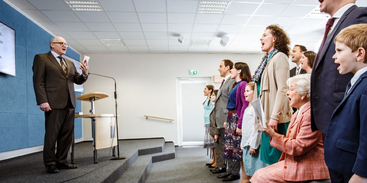 Young and old alike sing at a congregation meeting