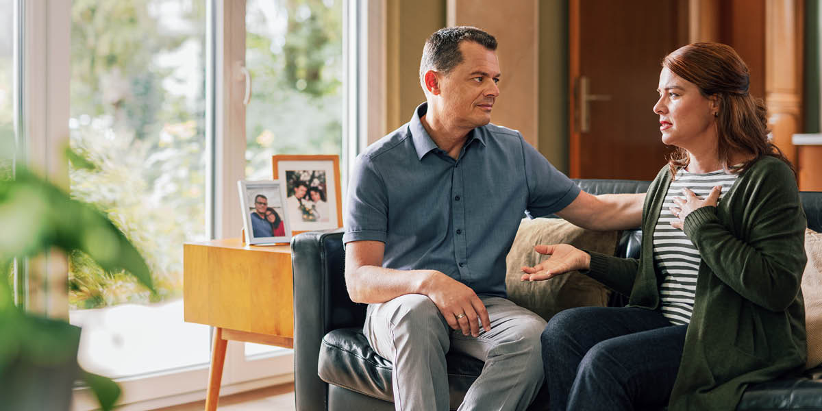 A man listening empathetically to his distressed wife.