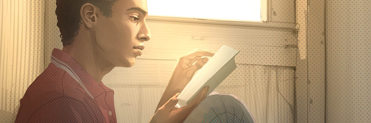 Un ragazzo legge la Bibbia.