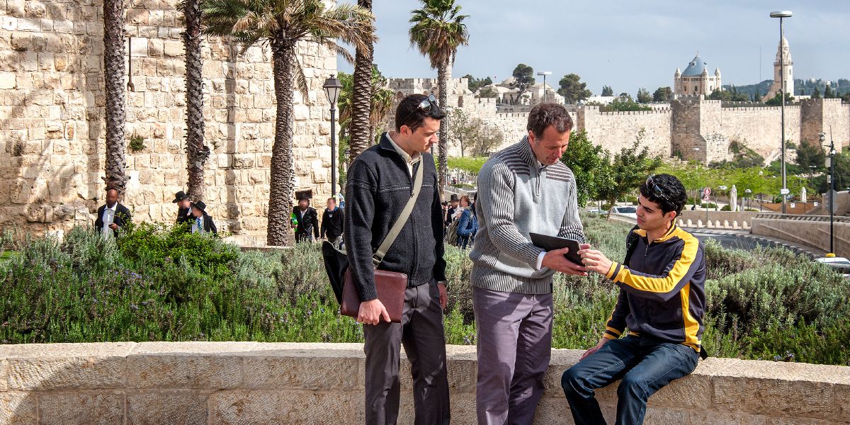 In Israele, due testimoni di Geova predicano a un uomo usando un tablet