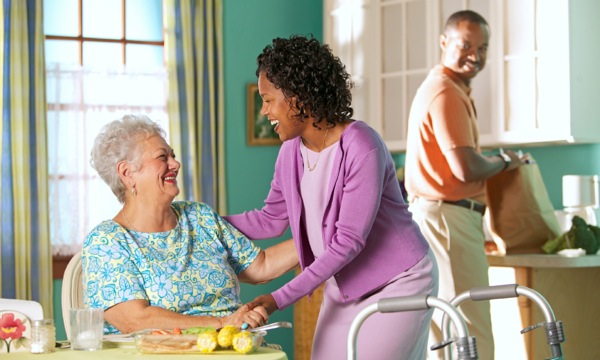 A Christian couple assisting an elderly disabled friend