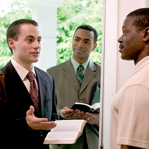A Bible student along with his teacher in the public ministry, sharing the good news with a man