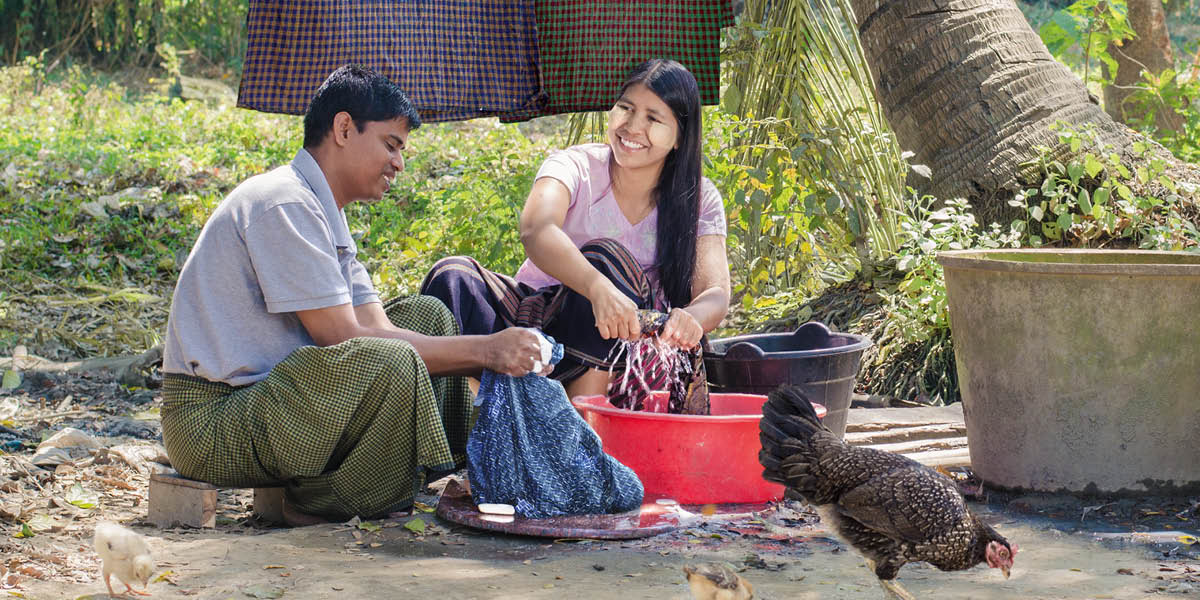 The brother and his wife happily washing their clothes.