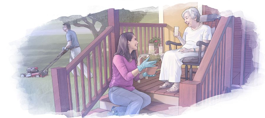 Een oudere vrouw die op een veranda zit terwijl een jong stel in de tuin werkt