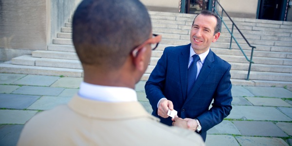 Two men exchanging names