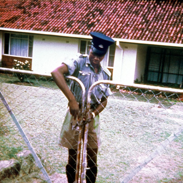 A policeman locking the gate of the branch property