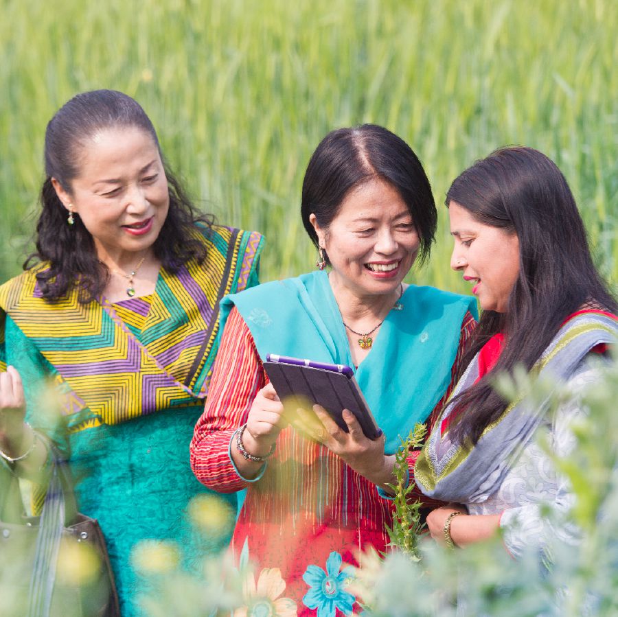 Kumiko uses an electronic device to witness in Nepal
