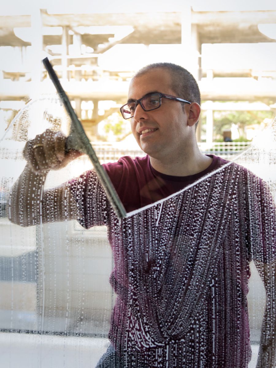 Jonathan washes a window