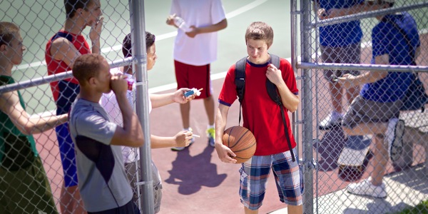 A teenage boy being offered cigarettes