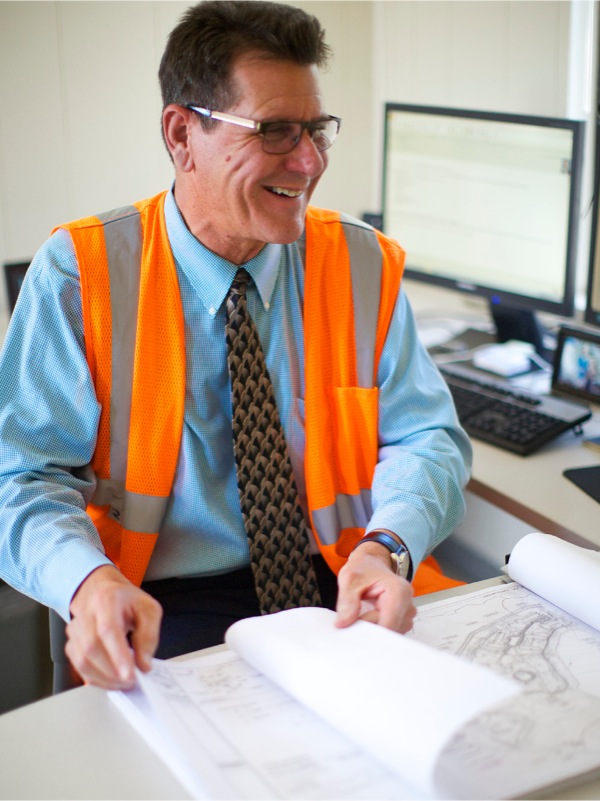 Kenneth reviewing construction plans