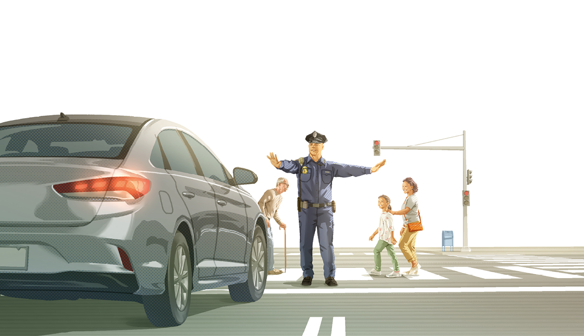 ایک پولیس والا ایک مصروف سڑک پر گاڑیوں کو روک رہا ہے اور فرق فرق عمروں کے لوگ سڑک پار کر رہے ہیں۔‏